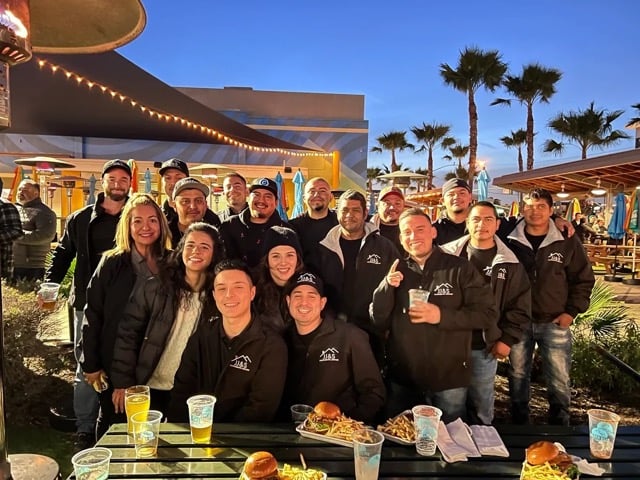Company Team Picture At Event Having Drinks