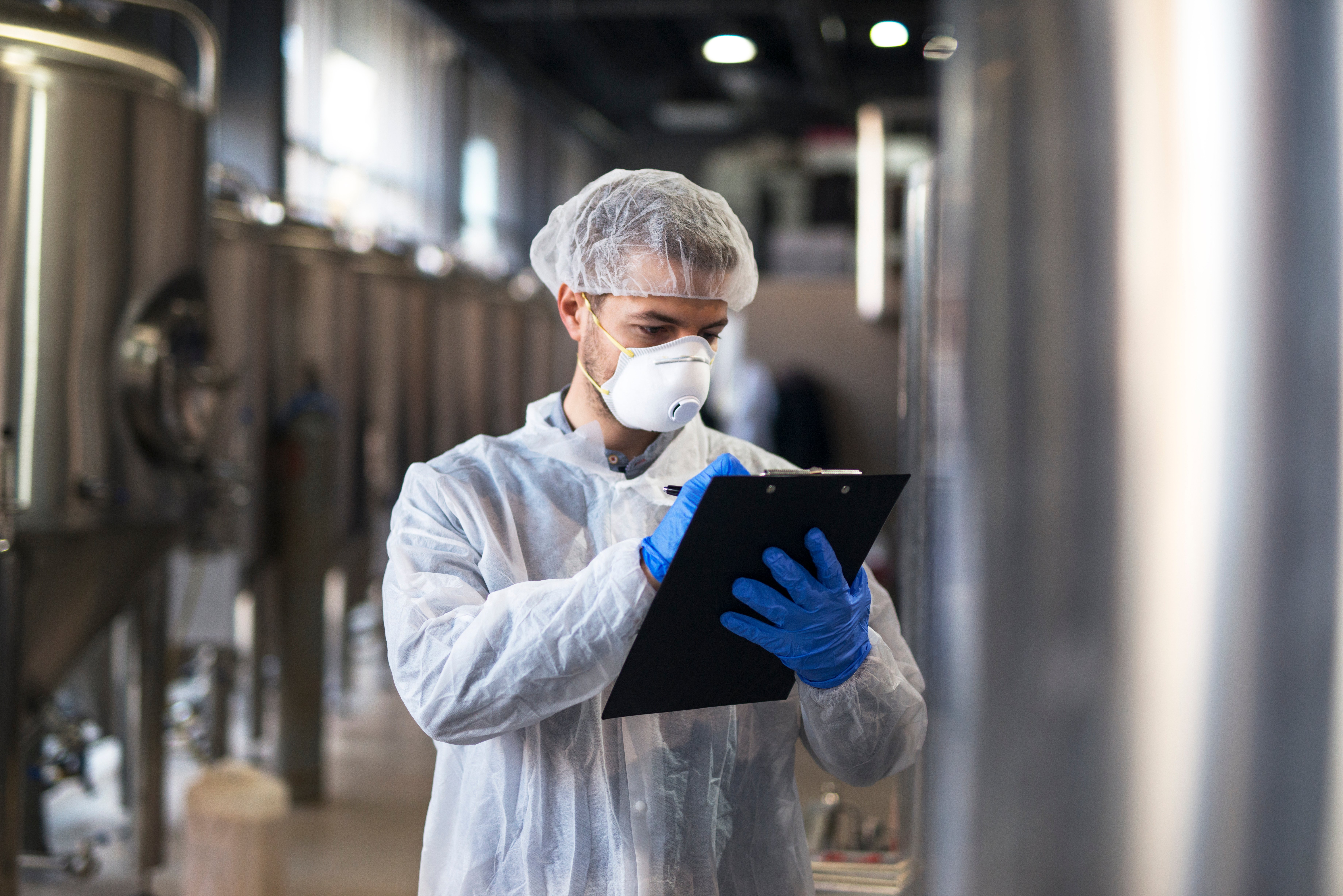 technologist-white-uniform-checking-quality-industrial-production-factory