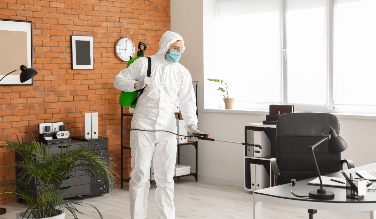 Asbestos Worker Cleaning An Office With Protection